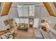 Bright living room with vaulted wood ceilings, white curtains, and stylish furnishings at 1003 W Divine St, Dunn, NC 28334