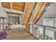 Cozy loft featuring wood-paneled ceiling, carpeted floors, and clear railings at 1003 W Divine St, Dunn, NC 28334
