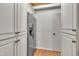 Large pantry features custom white cabinets, wood floors, and stainless refrigerator at 1003 W Divine St, Dunn, NC 28334