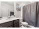 Full bathroom features a shower with a curtain, single sink vanity, and a framed picture at 1012 Ringhill Bluff Dr, Durham, NC 27704