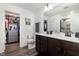Modern bathroom with double sinks, a large mirror, and a walk-in closet at 1012 Ringhill Bluff Dr, Durham, NC 27704
