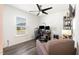 Bright bedroom featuring a ceiling fan, a cozy armchair, and a view of the backyard at 1012 Ringhill Bluff Dr, Durham, NC 27704