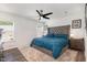 Cozy bedroom with a plush bed, ceiling fan, and natural light from the windows at 1012 Ringhill Bluff Dr, Durham, NC 27704