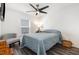 Cozy bedroom with a comfortable bed, neutral walls, ceiling fan, and natural light from the window at 1012 Ringhill Bluff Dr, Durham, NC 27704