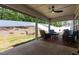 Relaxing covered patio with outdoor furniture, fan, and a view of the backyard at 1012 Ringhill Bluff Dr, Durham, NC 27704