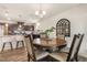 Open dining area with a round table, chairs, and a view of the modern kitchen at 1012 Ringhill Bluff Dr, Durham, NC 27704