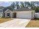 Charming single-story home featuring a spacious two-car garage and a well-maintained front yard at 1012 Ringhill Bluff Dr, Durham, NC 27704