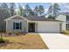 Inviting single-story home boasts a neat front yard and attached two-car garage at 1012 Ringhill Bluff Dr, Durham, NC 27704