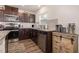 Well-equipped kitchen with stainless steel appliances, dark wood cabinets, and granite countertops at 1012 Ringhill Bluff Dr, Durham, NC 27704