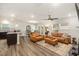 Spacious open-concept living room with leather furniture, ceiling fan, and adjoining dining area at 1012 Ringhill Bluff Dr, Durham, NC 27704