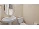 Well lit half bathroom featuring a sink with chrome faucet and a white toilet at 1027 Myers Point Dr, Morrisville, NC 27560