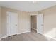 Neutral bedroom featuring modern floors and two doors, one leading to an adjacent room at 1027 Myers Point Dr, Morrisville, NC 27560