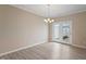 Bright dining area featuring a modern chandelier and sliding glass doors to a patio at 1027 Myers Point Dr, Morrisville, NC 27560