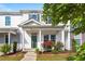 Charming townhome exterior with a covered porch, green door, and well-manicured landscaping at 1027 Myers Point Dr, Morrisville, NC 27560