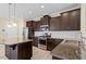 Modern kitchen featuring granite countertops, stainless steel appliances, and dark wood cabinetry at 1027 Myers Point Dr, Morrisville, NC 27560