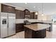 Modern kitchen with stainless steel appliances, granite countertops, and kitchen island at 1027 Myers Point Dr, Morrisville, NC 27560