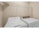 Laundry room featuring a washer, dryer, and wire shelving for storage at 1027 Myers Point Dr, Morrisville, NC 27560