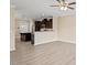 Open-concept living space featuring hardwood floors, ceiling fan, and a partial view of kitchen at 1027 Myers Point Dr, Morrisville, NC 27560