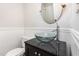 Bathroom with modern glass vessel sink, dark vanity, and wood-look beadboard at 105 Hiddenwood Ct, Garner, NC 27529