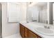 Bathroom with double sinks, white countertop, and wood cabinets at 105 Hiddenwood Ct, Garner, NC 27529