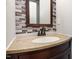 Bathroom with oval sink, dark vanity, and stacked stone backsplash at 105 Hiddenwood Ct, Garner, NC 27529