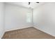 Bedroom featuring neutral carpet, light walls, and a bright window at 105 Hiddenwood Ct, Garner, NC 27529