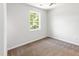 Bedroom with neutral carpet, light walls, and a window for natural light at 105 Hiddenwood Ct, Garner, NC 27529