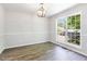 Open dining area with neutral paint, modern lighting, and large window, offering a bright and inviting space at 105 Hiddenwood Ct, Garner, NC 27529