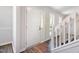 Bright entryway featuring wood floors, white trim, and a staircase, creating a welcoming and fresh first impression at 105 Hiddenwood Ct, Garner, NC 27529