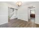 Open-concept living room with hardwood floors, modern lighting, and staircase, creating a warm and welcoming atmosphere at 105 Hiddenwood Ct, Garner, NC 27529
