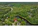 Stunning aerial view of a home near Lochmere Golf Club, nestled among lush greenery and overlooking a serene pond at 105 Highlands Lake Dr, Cary, NC 27518