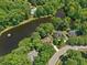 Overhead view of home near lake with swimming pool surrounded by mature trees at 105 Highlands Lake Dr, Cary, NC 27518