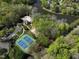 Aerial view showing the lake, community pool, and tennis courts surrounded by trees at 105 Highlands Lake Dr, Cary, NC 27518