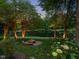 Beautiful backyard with a fire pit and a hammock overlooking a tranquil lake at 105 Highlands Lake Dr, Cary, NC 27518