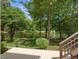 Picturesque backyard with waterfront views, a charming fire pit, and lush green landscaping for outdoor enjoyment at 105 Highlands Lake Dr, Cary, NC 27518