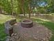 Backyard with a stone fire pit and stone bench, perfect for outdoor relaxation at 105 Highlands Lake Dr, Cary, NC 27518
