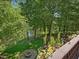 Scenic backyard view with lush landscaping and waterfront featuring a fire pit and hammock at 105 Highlands Lake Dr, Cary, NC 27518