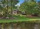 Tranquil backyard featuring a bench, hammock, and a stone fire pit near the lake at 105 Highlands Lake Dr, Cary, NC 27518