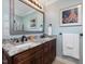 Bathroom featuring a granite countertop, dual sinks, a dark wood vanity, and an octopus picture on the wall at 105 Highlands Lake Dr, Cary, NC 27518