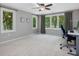 Bright bedroom features large windows with views to outside and neutral carpet at 105 Highlands Lake Dr, Cary, NC 27518