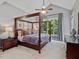 This is a beautiful bedroom with a four-poster bed and high ceilings at 105 Highlands Lake Dr, Cary, NC 27518