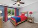 Bedroom with a red and blue color scheme, and large window showcasing outdoor views at 105 Highlands Lake Dr, Cary, NC 27518