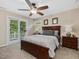 Cozy bedroom with a balcony, ceiling fan, and carpet flooring at 105 Highlands Lake Dr, Cary, NC 27518