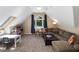 Bonus room with a vaulted ceiling, a large window, and a comfortable brown sectional sofa at 105 Highlands Lake Dr, Cary, NC 27518