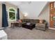 Bonus room featuring a vaulted ceiling, an arched window, and a sectional sofa with decorative throw pillows at 105 Highlands Lake Dr, Cary, NC 27518