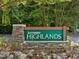 Elegant stone sign welcomes you to Lochmere Highlands, with lush greenery enhancing the community's entrance at 105 Highlands Lake Dr, Cary, NC 27518
