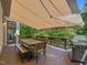 Spacious outdoor dining area with retractable awning providing a comfortable space for outdoor gathering at 105 Highlands Lake Dr, Cary, NC 27518
