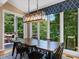 Bright dining room with lake view, modern light fixture, and large windows at 105 Highlands Lake Dr, Cary, NC 27518