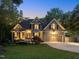 Charming two-story home with mature trees, a manicured lawn, and a two-car garage at 105 Highlands Lake Dr, Cary, NC 27518