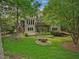 Spacious backyard with a stone fire pit, lush lawn and inviting multi-level deck at 105 Highlands Lake Dr, Cary, NC 27518